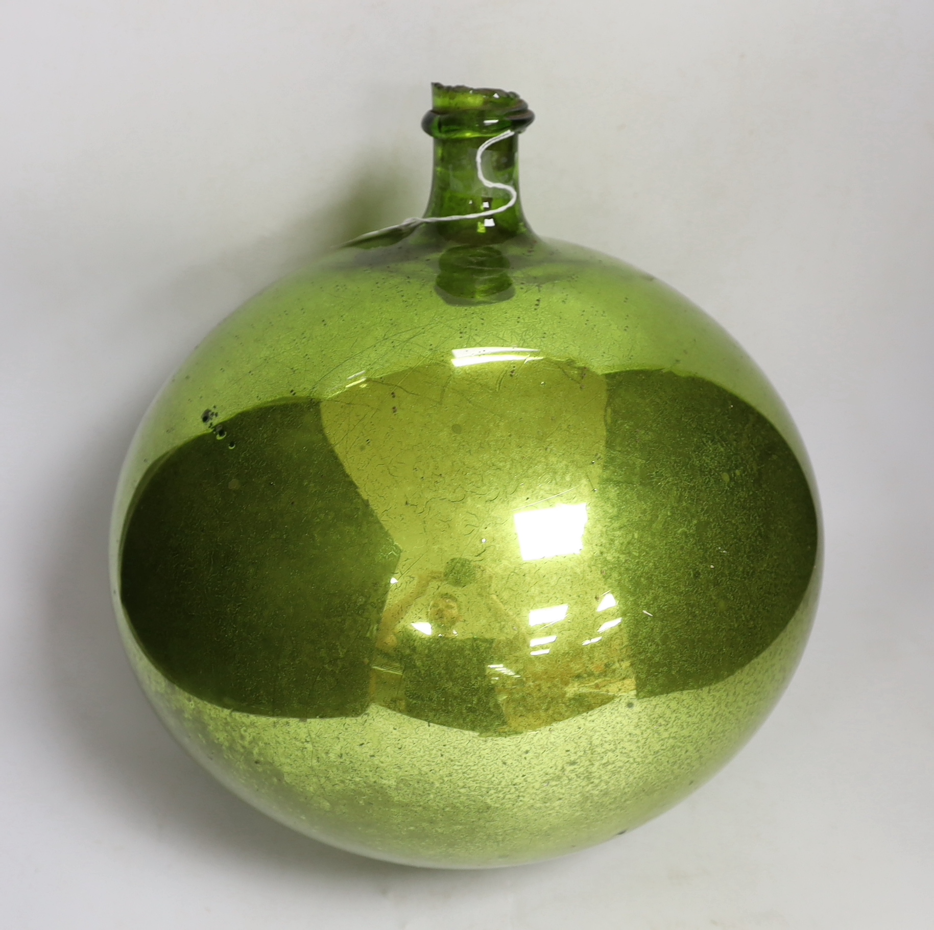 A large metallic lime green witches ball, 34cm high